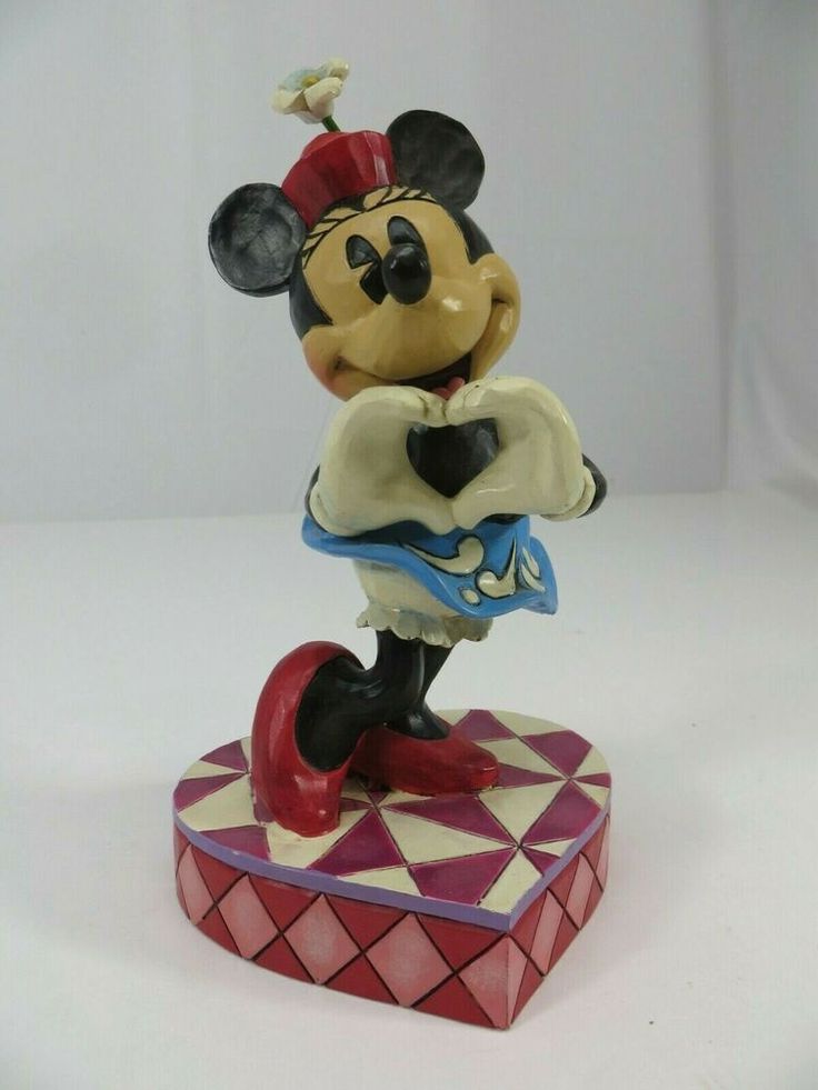 a figurine of mickey mouse on a red and white checkered base