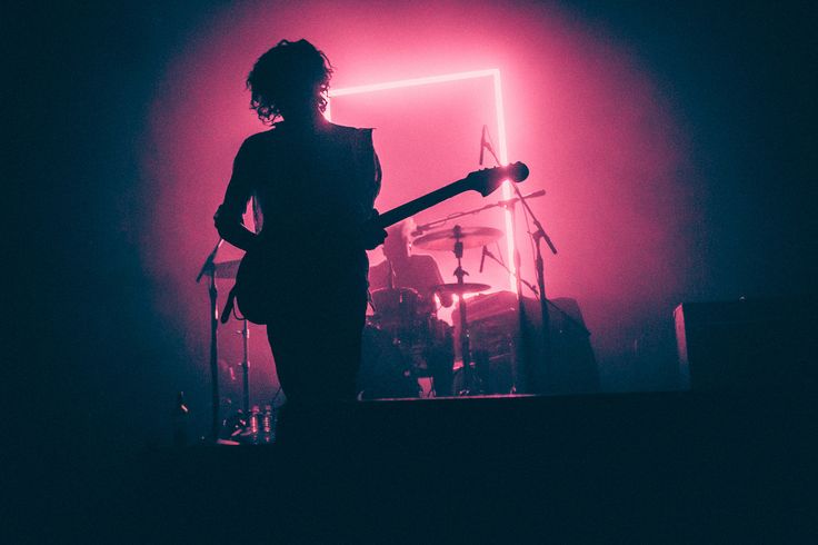 a person standing in front of a drum set