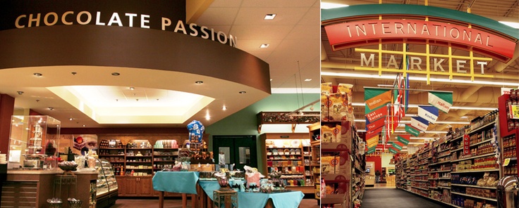 the interior of a chocolate shop with blue chairs and tables in front of shelves full of chocolates