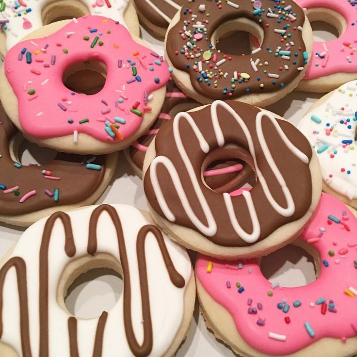 there are many donuts with chocolate frosting and sprinkles on them