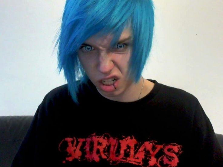 a young man with blue hair wearing a shirt that says virtly's