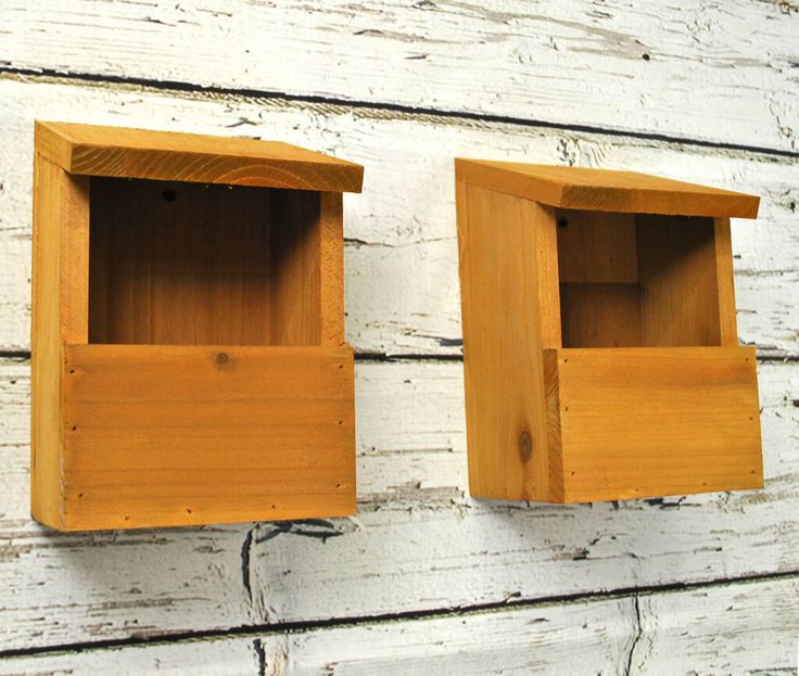 two wooden boxes mounted to the side of a wall