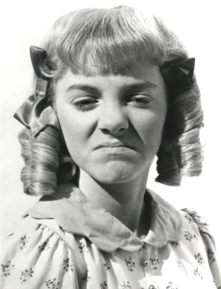 a black and white photo of a woman with hair in curls on her head