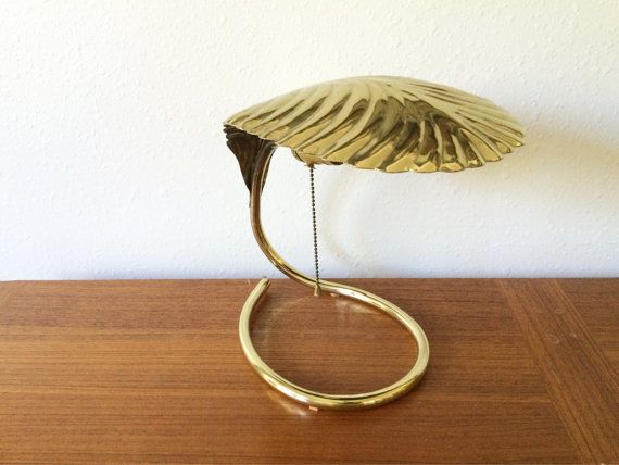 a gold sculpture sitting on top of a wooden table