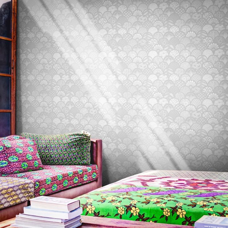 a living room filled with furniture and a wallpaper covered in floral designs on the walls