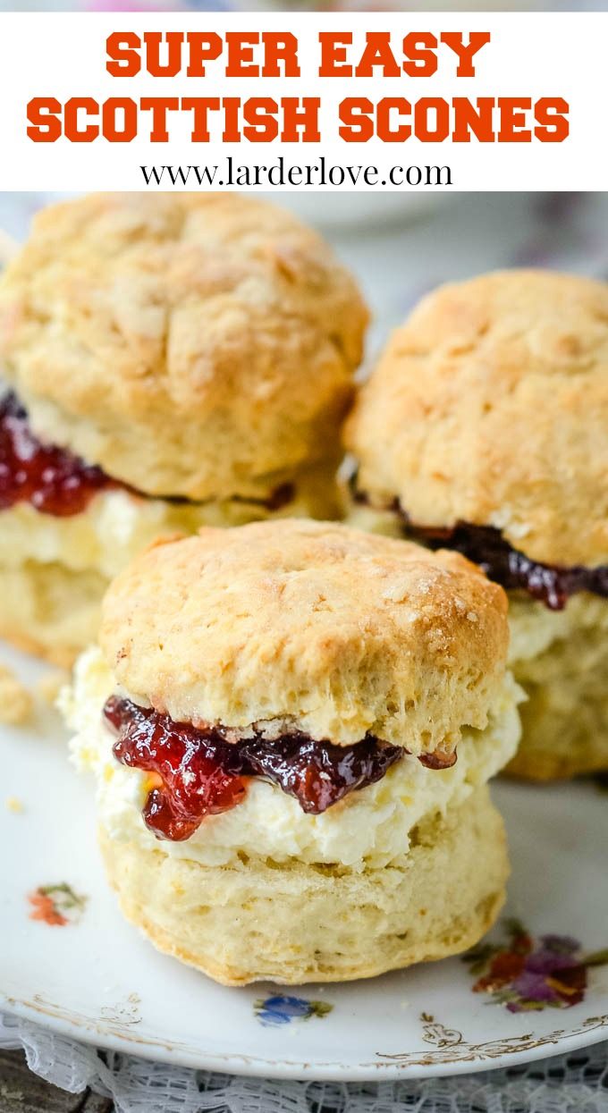 three biscuits filled with cream and jelly on a white plate