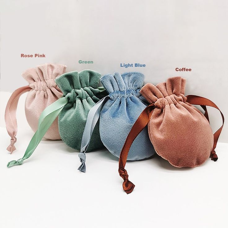 three small pouch bags with different colored ribbons