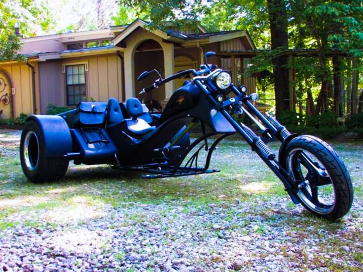 a black motorcycle parked in front of a house