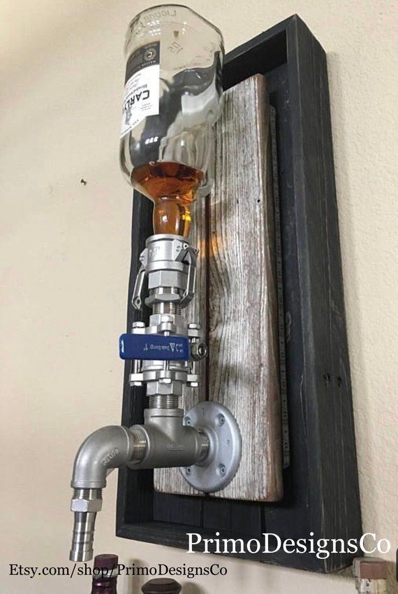 a wall mounted bottle dispenser on the side of a wall