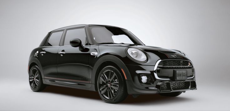 the front end of a black mini countryman parked in an empty room with grey background