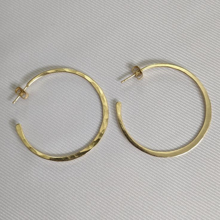 Brass hoop earrings in studs Tapered ends Weightless Goldstone 1.77 inches (4.5 cm) top to bottom 4.9 grams Trendy Yellow Gold Brass Hoop Earrings, Modern Gold Brass Hoop Earrings, Chic Brass Nickel-free Hoop Earrings, Modern Gold Hammered Hoop Earrings, Brass Small Hoop Earrings For Everyday, Small Brass Hoop Earrings For Everyday, Classic Hammered Hoop Earrings For Everyday, Classic Everyday Hammered Hoop Earrings, Modern Yellow Gold Brass Hoop Earrings