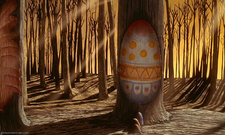 an easter egg sitting in the middle of a forest