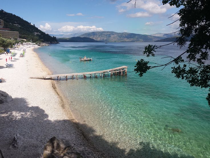 the beach is clear and blue with people on it