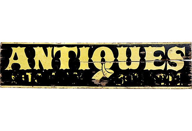 an antique sign that says antiques on it