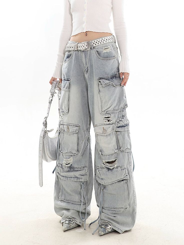 Experience the ultimate blend of streetwise flair and classic comfort with our Distressed Wide-Leg Denim Cargo Pants.Made with premium denim, these pants boast a relaxed wide-leg fit and a natural waist design, providing a comfortable experience without compromising on style. The distressed details and multiple pockets echo a laid-back vibe while adding practicality and edge to your look. These versatile pants serve as the perfect canvas for a variety of styling options – pair them with a sleek Casual Wide-leg Jeans With Belt Loops, Y2k Wide Leg Flare Jeans With Pockets, Y2k Style Wide Leg Flare Jeans With Pockets, Y2k Wide Leg Cargo Jeans, Denim Blue Wide Leg Y2k Cargo Jeans, Distressed Wide Leg Cargo Jeans For Fall, Y2k Wide Leg Medium Wash Cargo Jeans, Y2k Wide Leg Cargo Jeans Medium Wash, Y2k Style Wide Leg Medium Wash Cargo Jeans