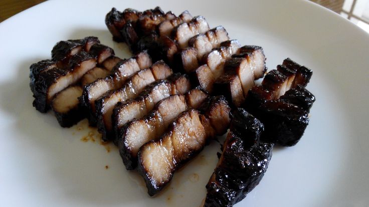 some sliced up meat on a white plate