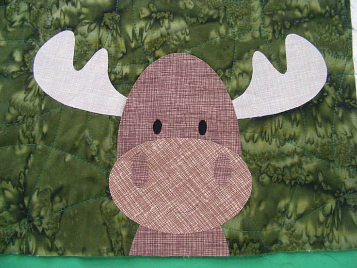 a close up of a quilted moose head