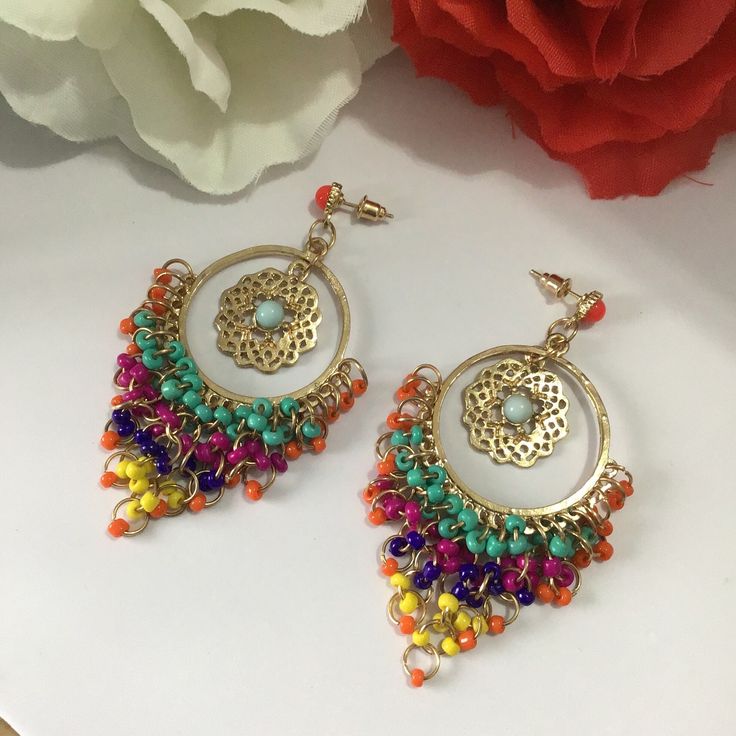 Very beautiful, elegant and high quality hand crafted golden multi colour earrings will add charm and charisma to your beautiful personality. Wear it with any of your formal or casual outfits and grab compliments all the way. Main Colour: gold Beads: Seed Bead Bead Colour: Multi Colour  Earrings Size: L x 7.7 cm / W x 3.8 cm Luxury Multicolor Bollywood Jhumkas, Multicolor Metal Dangle Chandelier Earrings, Multicolor Metal Dangle Hoop Earrings, Multicolor Metal Hoop Earrings, Multicolor Nickel-free Hoop Earrings For Festivals, Multicolor Metal Chandelier Earrings, Traditional Multicolor Beaded Earrings Nickel Free, Traditional Gold Beaded Earrings With Colorful Beads, Multicolor Dangle Beaded Earrings For Celebrations