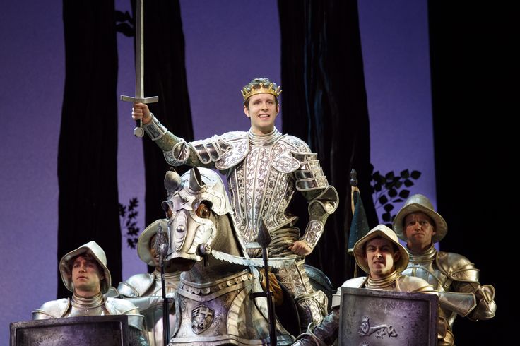 the actors are dressed in medieval costumes and holding their swords as they stand on stage