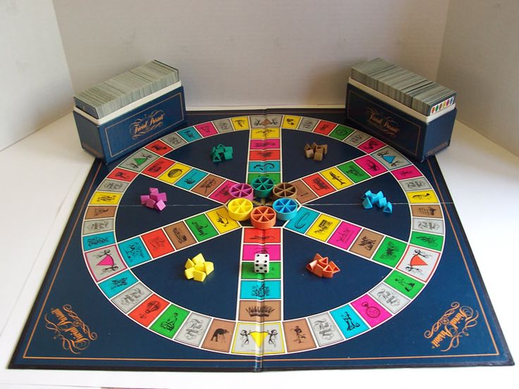 a board game set up on top of a white table with other items around it