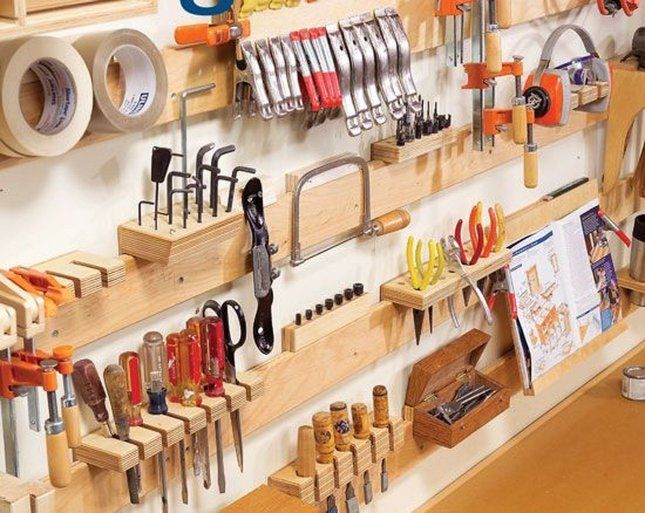 many different tools are hanging on the wall