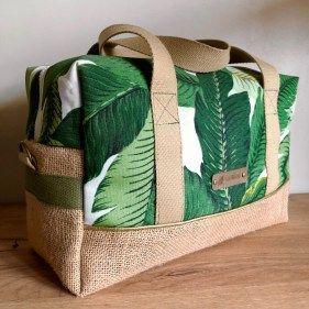 a green and white bag sitting on top of a wooden table