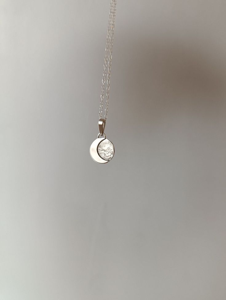 "This sterling silver pendant with a crescent moon is a handmade piece and  unique.  Each moon has its own special shape, so there are no two alike. If you prefer a specific position for the moon, please write to me. Additionally, the silver chain is adjustable, allowing you to wear it at your preferred length, between 40 and 45 cm. It's the perfect accessory to add a special touch to your unique style. To make this pendant, we use the highest quality silver sourced ethically from European mines Spiritual Sterling Silver Moon Phase Necklace, Silver Pendant Jewelry With Sun And Moon Design, Sterling Silver Sun And Moon Round Pendant Jewelry, Sterling Silver Charm Necklace With Sun And Moon Design, Sterling Silver Sun And Moon Spiritual Necklace, Sterling Silver Spiritual Necklace With Sun And Moon Design, Spiritual Sterling Silver Necklace With Sun And Moon Design, Spiritual Sterling Silver Sun And Moon Necklace, Celestial Silver Jewelry With Round Pendant