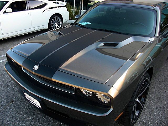 a silver and black sports car parked in a parking lot