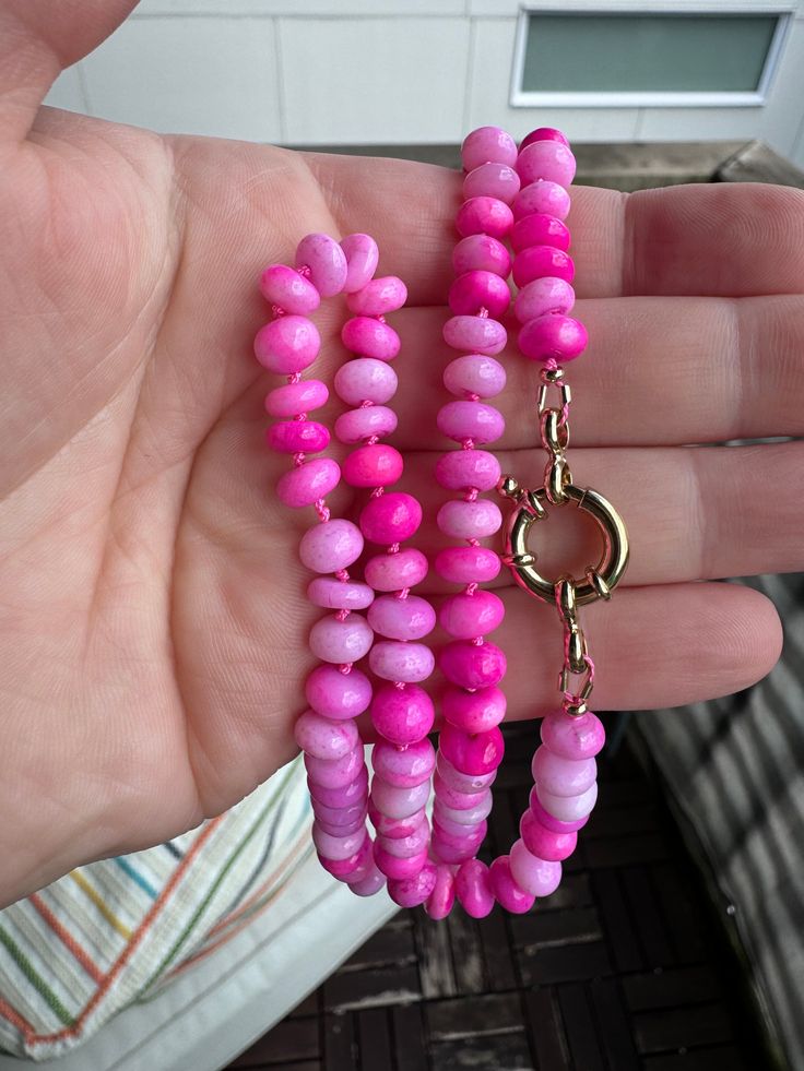 This vibrant pink necklace was made with shaded opal pink rondelles and hand knotted on hot pink silk thread. Finished with a 14k gold vermeil mariner clasp which you can easily add charms to.  This necklace is 23" long and the beads range in size from 7.5 to 8mm. Pink Hand-strung Necklace As Gift, Pink Hand-strung Necklace For Gift, Pink Rondelle Jewelry With Polished Beads, Pink Polished Rondelle Beads Jewelry, Pink Rondelle Polished Beads Jewelry, Pink Gemstone Bead Necklaces, Pink Opal Single Strand Beaded Necklace As Gift, Pink Round Gemstone Beads Necklace, Pink Single Strand Round Jewelry