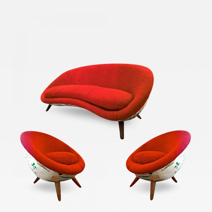 three red chairs and one white chair are in the shape of an egg shaped couch