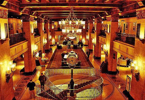 the inside of a large building with chandeliers and lights on it's ceiling