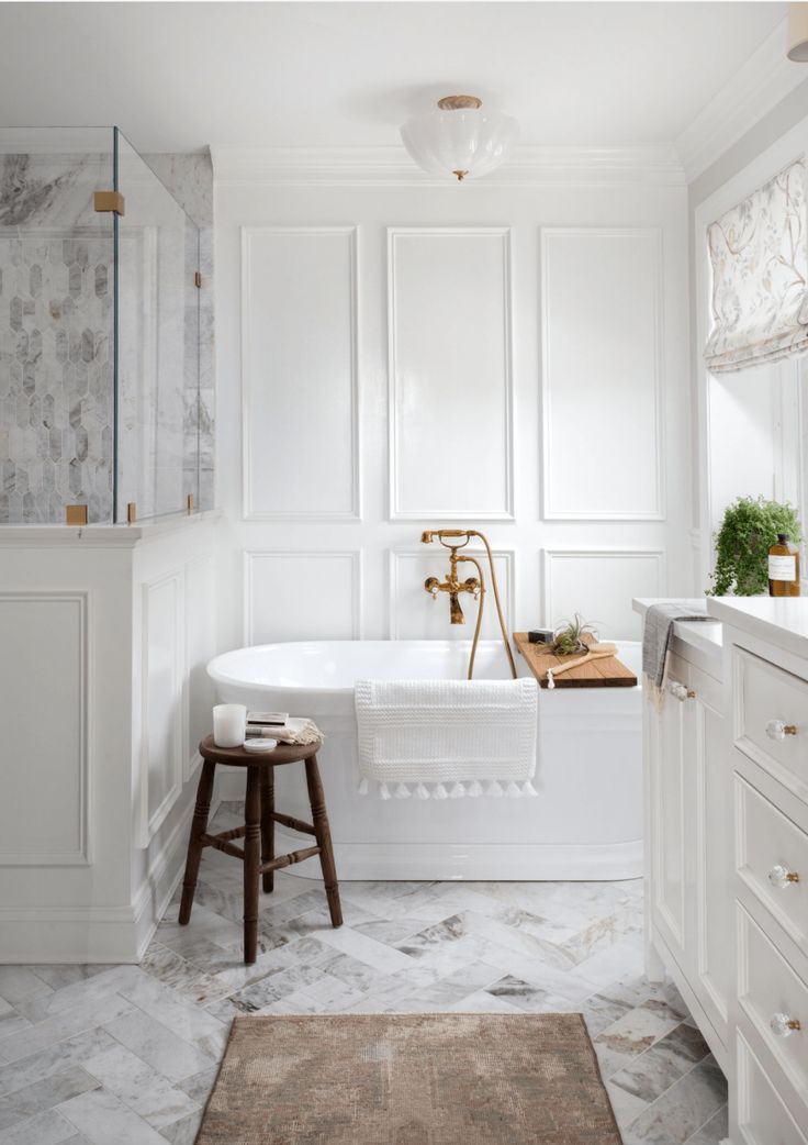 a bathroom with white walls and marble flooring is featured on instagram for an article