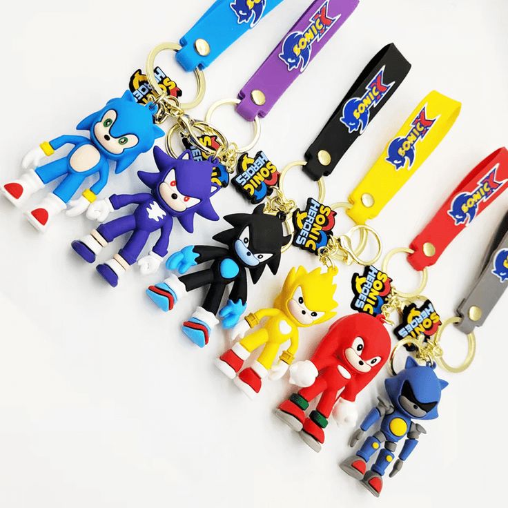 several different colored keychains with cartoon characters on them, all in various shapes and sizes