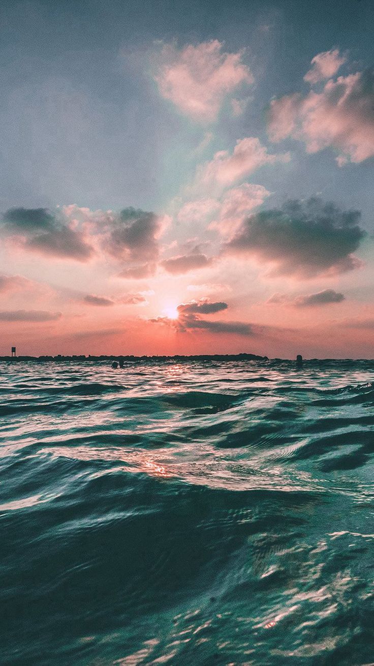 the sun is setting over the ocean as it reflects in the water's surface