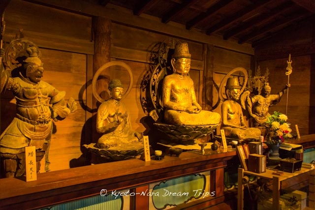 some statues are on display in a room