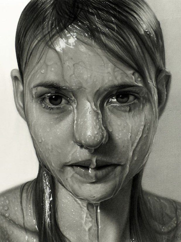 a black and white photo of a woman with water on her face