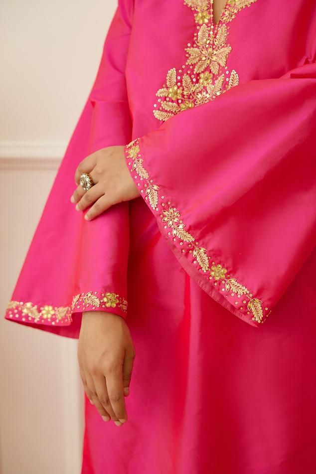 Rani pink kurta featuring notched neckline and full sleeves with sequin embroidered floral patterns. Paired with a printed tiered sharara and a tasselled dupatta with gota border., Fit: Relaxed Festive Pink Kurta With Zari Work, Pink Straight Kurta Sharara For Navratri, Pink Raw Silk Anarkali Set With Dabka Work, Traditional Anarkali Set In Pink With Gota Work, Pink Sharara With Straight Kurta For Navratri, Pink Bollywood Style Dola Silk Kurta, Pink Bollywood Dola Silk Kurta, Pink Raw Silk Kurta With Dabka Work, Pink Kurta With Gota Work And Traditional Drape