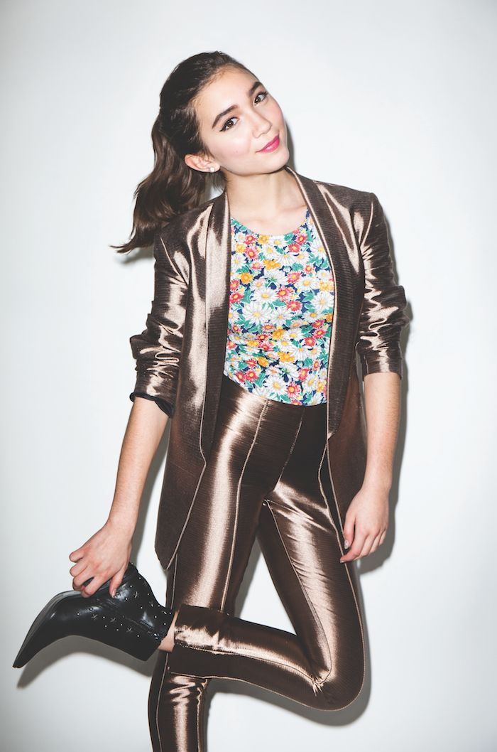 a woman in metallic clothing posing for the camera with her hand on her hip,