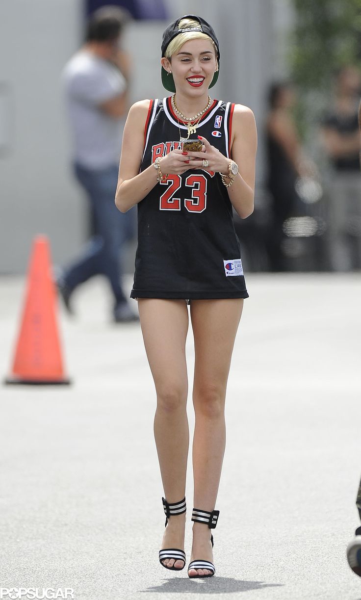 a woman walking down the street with her cell phone