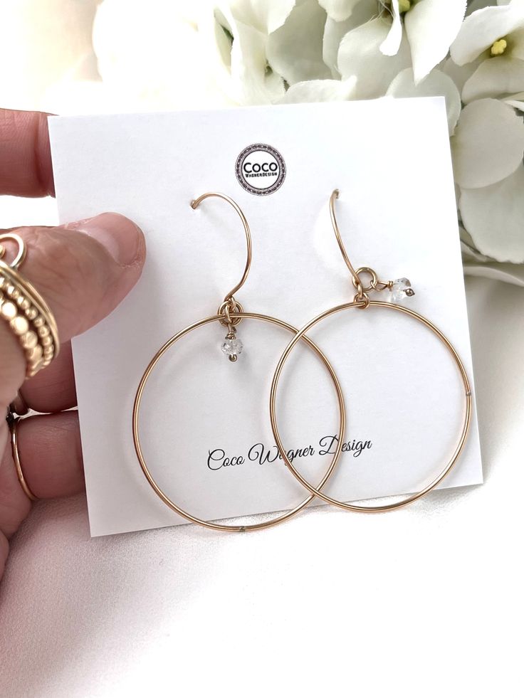 Just as effortless as they are simple, these hoop earrings are an essential everyday piece. Item Details: • This listing is for A PAIR ( 2 pieces ) earrings.• All metal is components are sterling silver and 14k gold-fill• Hoops measure 40mm in diameter.• Herkimer quartz crystals prized, each Herkimer diamond is a natural entity and no stone is identical.• The order will arrive in a gift-wrapped box and free polishing cloth. It will be ready for gift giving. All our work is custom-made by hand in Nickel-free Small Hoop Earrings In 14k Gold Filled, Delicate 14k Gold Filled Hoop Jewelry, Dainty 14k Gold Filled Hoop Jewelry, Dainty Recycled Gold Round Hoop Earrings, Dainty Recycled Gold Hoop Earrings, Delicate Gold Hoop Earrings In Brass, Dainty Adjustable Hoop Earrings For Anniversary, Minimalist 14k Gold-filled Hoop Jewelry, Delicate Gold Brass Hoop Earrings