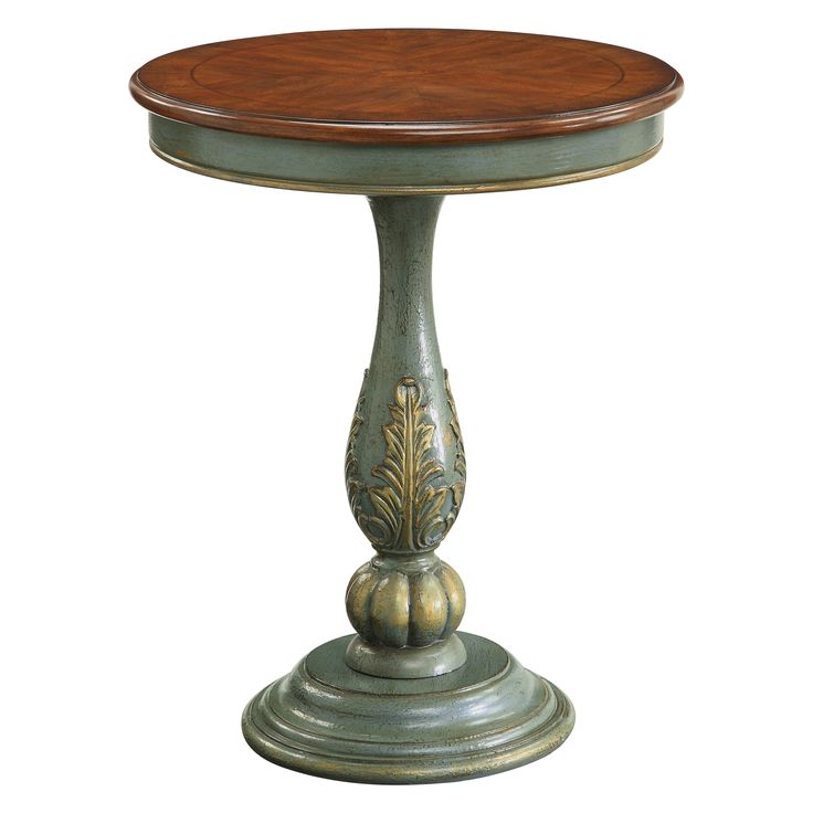 a small wooden table with an ornate design on the top and bottom, against a white background