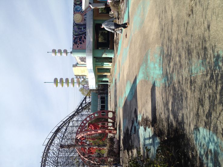 an abandoned roller coaster sits on the side of a building