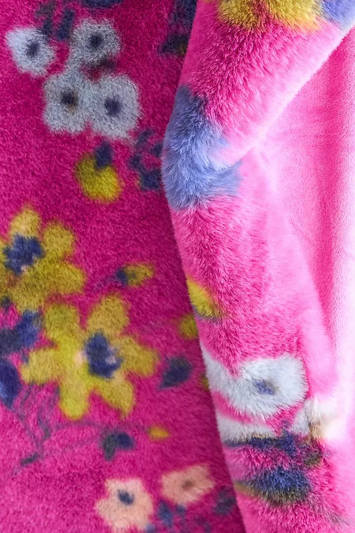 the pink and blue flowers are all over the fabric on this jacket, which is very soft