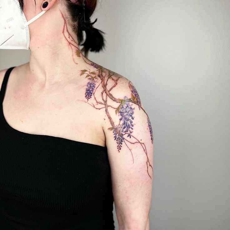 a woman with tattoos on her neck and chest is holding a toothbrush in her mouth