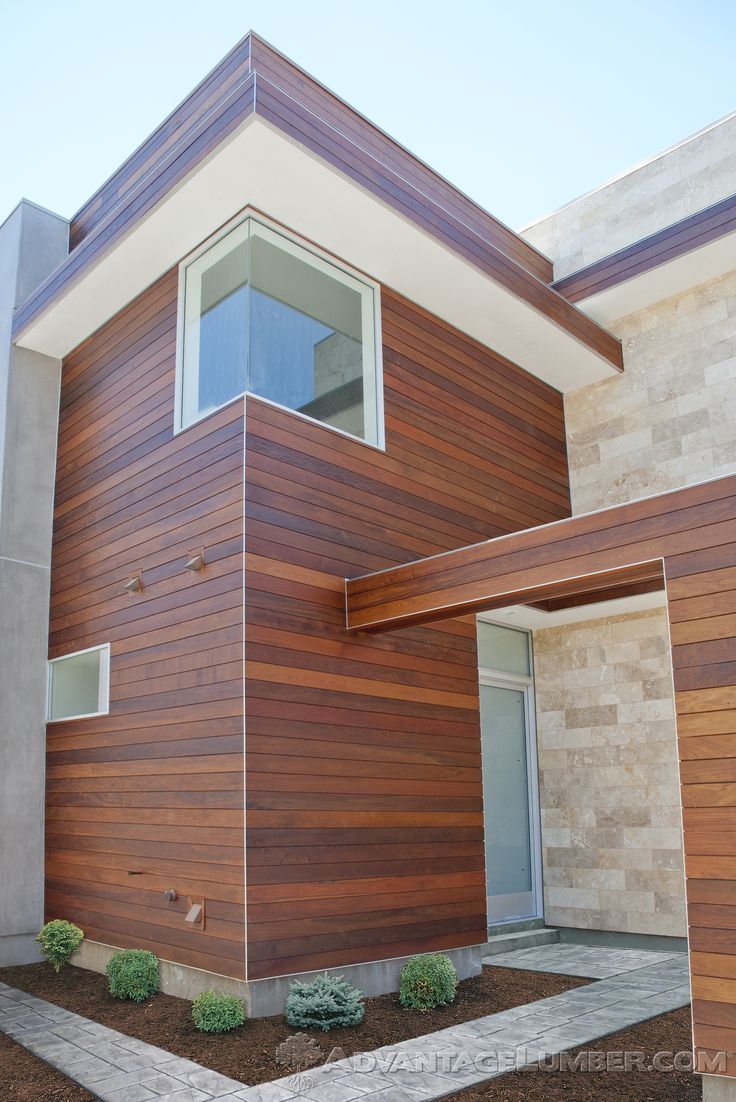 a modern house with wood siding on the side