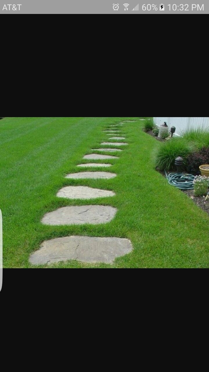 there is a stone path in the grass