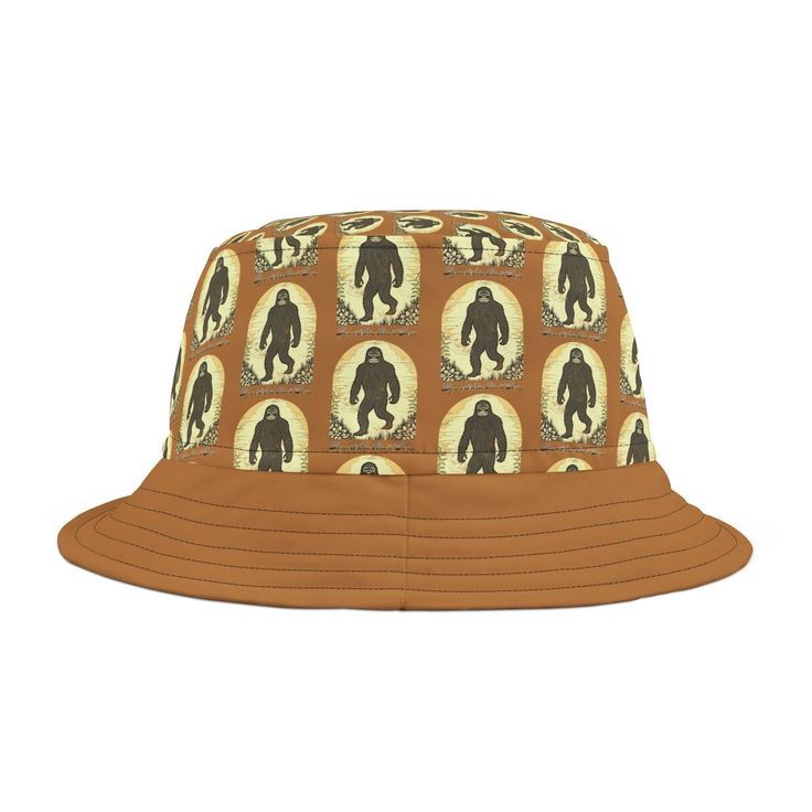 The Squatchin Ain't Easy Bucket Hat is the perfect adventure hat for your next trip. With its great color and fun style, this bucket hat is not only practical but also adds a touch of personality to your outdoor wardrobe. Made from 100% polyester, it offers durability and protection against the elements.  This bucket hat is inspired by the legendary Bigfoot, Sasquatch, and Yeti creatures, making it a must-have for fans and enthusiasts. Its unique design captures the essence of adventure and adds a fun element to your camping or hiking gear. Whether you're exploring the wilderness or simply enjoying a sunny day, this bucket hat will keep you shaded and comfortable. Available in two sizes, you can choose the perfect fit for your head. The hat features two stitching color options, allowing yo Outdoor Bucket Hat One Size, Brown Retro Hat For Outdoor, Adjustable Fit Bucket Hat For Outdoor Activities, Retro Curved Brim Sun Hat For Outdoor, Retro Summer Hats For Outdoor Activities, Retro Sun Hat For Outdoor Use, Retro Outdoor Hat With Curved Brim, Casual Bucket Hat With Curved Brim For Hiking, Casual Bucket Hat For Camping