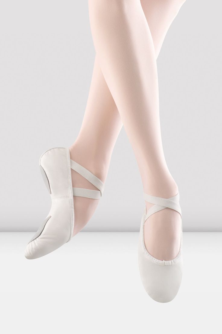 the feet of a ballerina in white shoes