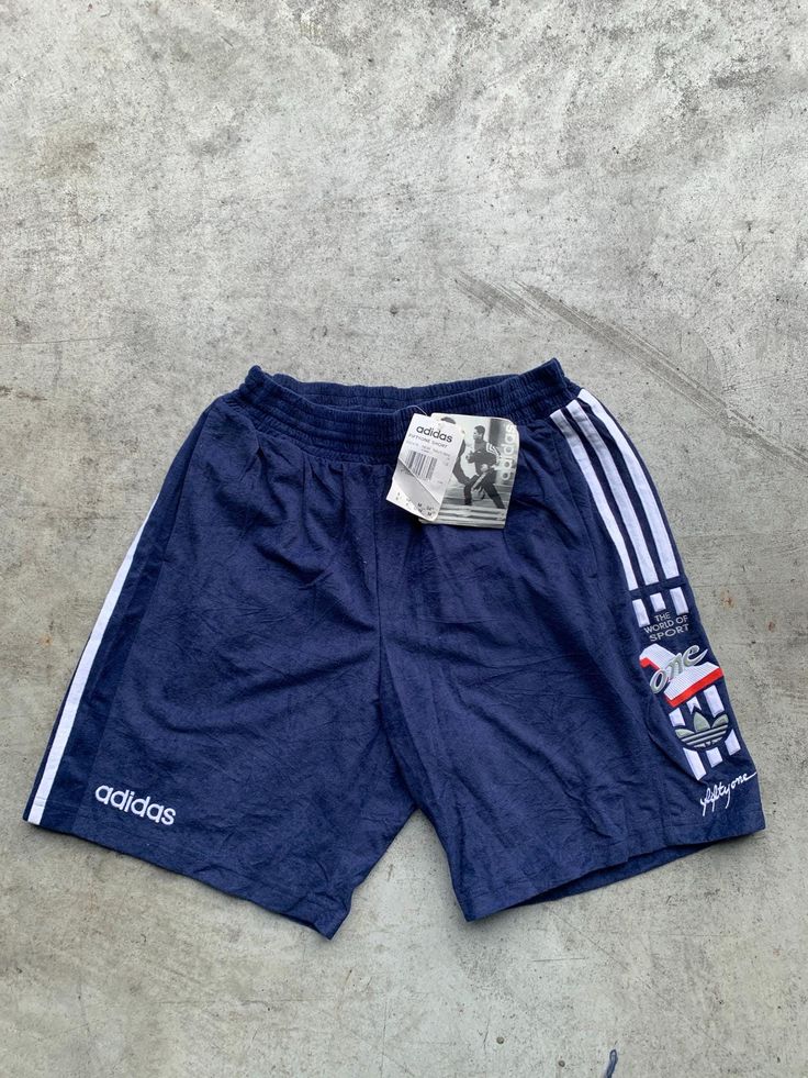 Vintage Adidas Deadstock Blue and White Sprinter Short Size M in great condition without any holes. The shorts are stretchy. Size: M (see measurements) Material: 20% Cotton, 80% Polyester Measurements: - Total length: 47 cm(18.5") - Waist: 36 cm(14.1") - Waist stretched: 50cm(19.6") NOTE: Due to the age, clothing/items can shrink or it may be that the sizing from that time the item was made in, is not the same as the sizing in modern clothing and current sizes. Make sure you check our measuremen Affordable Adidas Three Stripes Shorts, Adidas Logo Shorts For Summer, Adidas Logo Cotton Shorts For Summer, Sportswear Shorts With Three Stripes For Summer, Adidas Logo Sportswear Shorts For Summer, Sporty Adidas Logo Shorts For Summer, Summer Sports Shorts With Three Stripes, Adidas Logo Athleisure Summer Shorts, Adidas Logo Summer Athleisure Shorts