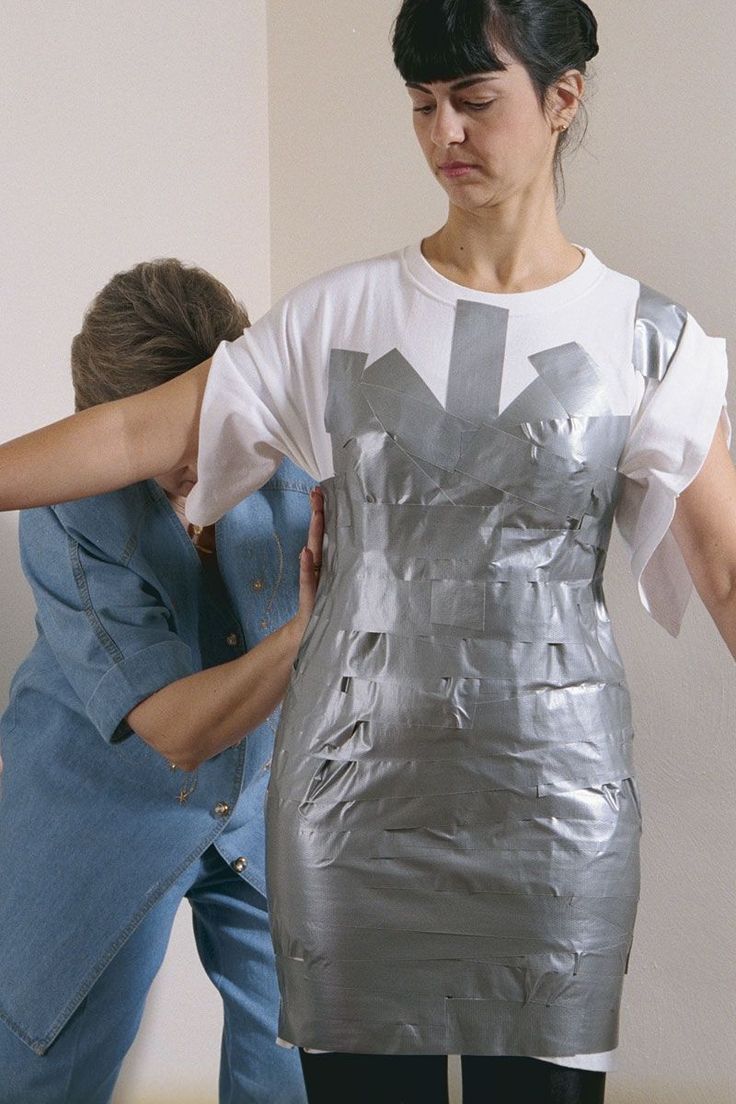 two women are dressed up in silver clothing